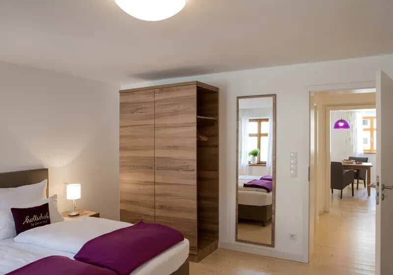 The bedroom in the cobbler's house with a view of the open room door.