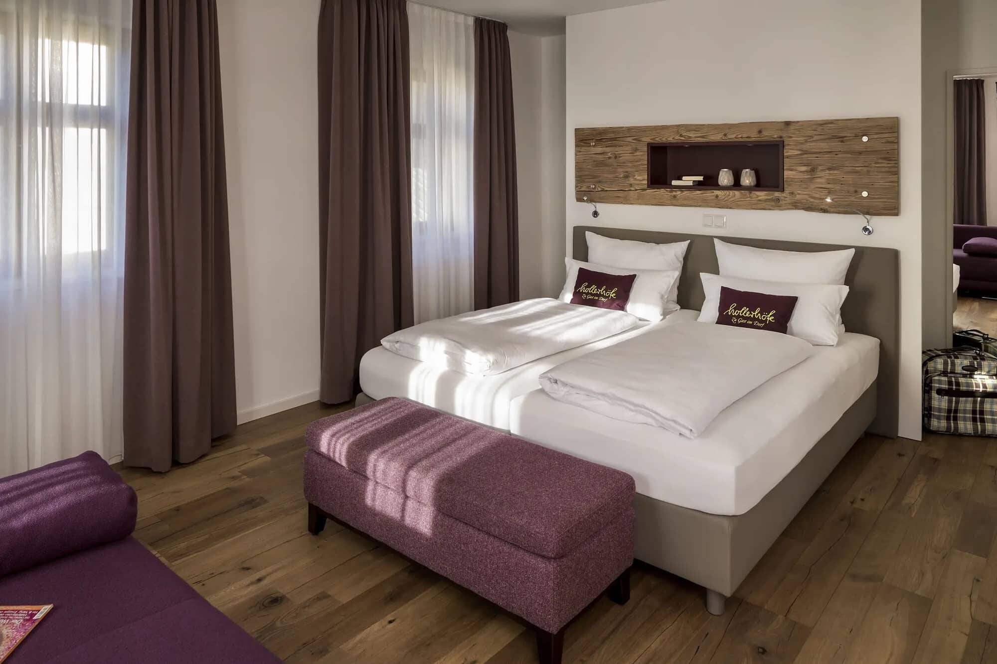 A large double bed with high mattresses in a Hollerhöfe holiday home.